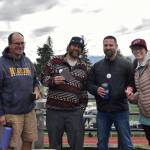 School Board member Tim Daugherty, volunteer Tristan Condon, Lt. Ryan Browning and Anna Meredith flip burgers and spread awareness of Planet Youth Homer during the 2025 Homer High School homecoming game on Saturday, Sept. 13. (Chloe Pleznac/Homer News)