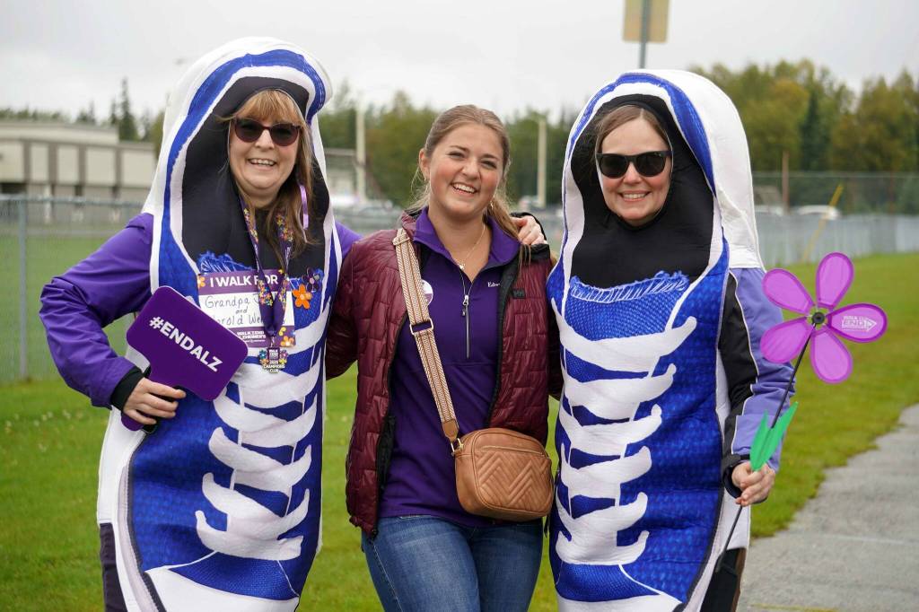 Sara Hondel, Anna DeVolld and Heidi Sorrell stand for a photo during the Third Annual Kenai Peninsula Walk to End Alzheimers on North Tinker Lane in Kenai, Alaska, on Saturday, Sept. 13, 2025. (Jake Dye/Peninsula Clarion)