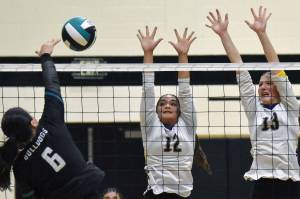 Nikiski's Halle Blades attacks against Homer's Alysha Nyvall and Madalyn Miotke on Tuesday, Sept. 23, 2025, at Nikiski Middle-High School in Nikiski, Alaska. (Photo by Jeff Helminiak/Peninsula Clarion)