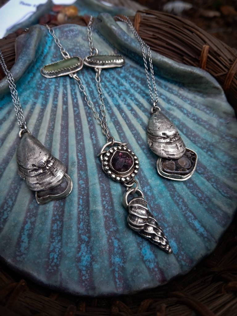 Jewelry by Carley Conemac, crafted from metal clay shells and stone, is on display through October in the artists solo exhibit at Homer Council on the Arts. Photo provided by Carley Conemac