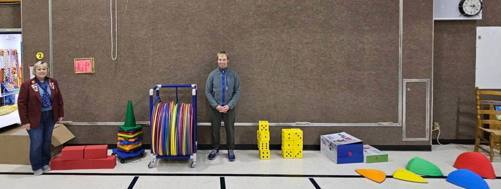Homer Elks Lodge #2127 Exalted Ruler Jill Hockema (left) and Paul Banks Elementary School PE teacher Tony Perelli are photographed with sports equipment purchased by the Paul Banks PTA with grant funds donated by the Homer Elks Lodge in June 2025 in Homer, Alaska. Photo provided by Jill Hockema