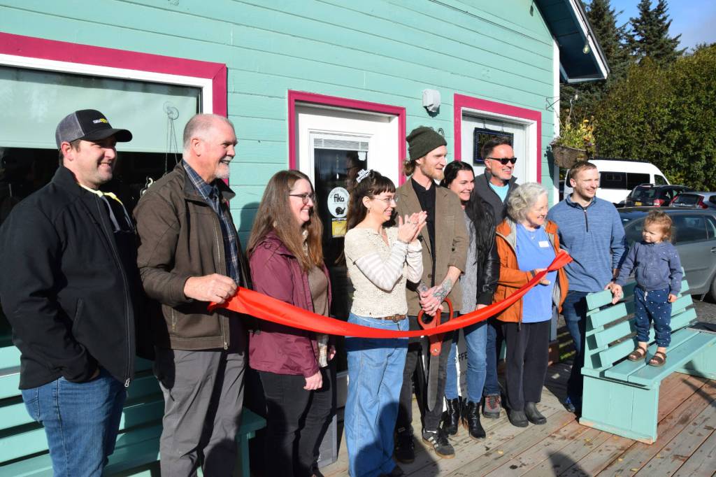 Homer Chamber of Commerce staff and board members, City of Homer staff and Fika Coffee Roasters owners Sierra Moskios and Tyler Schlieman (center) gather for a ribbon cutting ceremony during Fikas grand opening at ZenDen Cafe on Tuesday, Oct. 7, 2025, in Homer, Alaska. (Delcenia Cosman/Homer News)