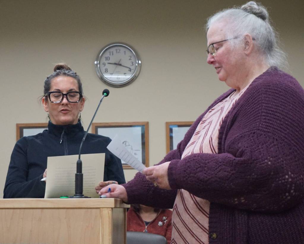City of Homer clerk Renee Krause (right) conducts the swearing in ceremony for Homer City Council member Storm Hansen on Monday, Oct. 13, 2025, in the Homer City Hall Cowles Council Chambers, following her reelection to the council in Homer, Alaska. Photo courtesy of Julie Engebretsen