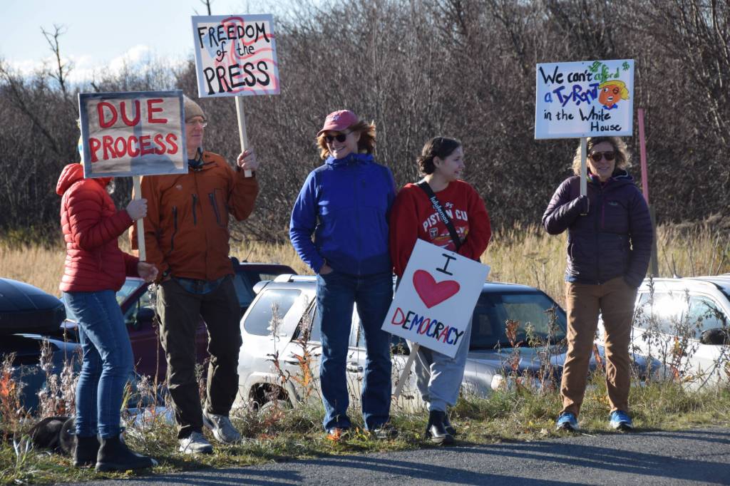 Protesters hold signs championing due process and freedom of the press during the No Kings demonstration on Saturday, Oct. 18, 2025, in Homer, Alaska. (Delcenia Cosman/Homer News)