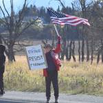 A protester waves an American flag and holds a sign that reads Be Brave Resist Tyranny during the No Kings demonstration on Saturday, Oct. 18, 2025, in Homer, Alaska. (Delcenia Cosman/Homer News)