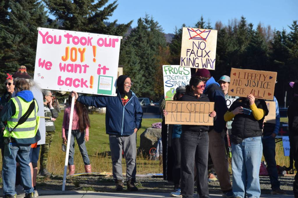 Protesters hold signs during the No Kings demonstration on Saturday, Oct. 18, 2025, in Homer, Alaska. (Delcenia Cosman/Homer News)