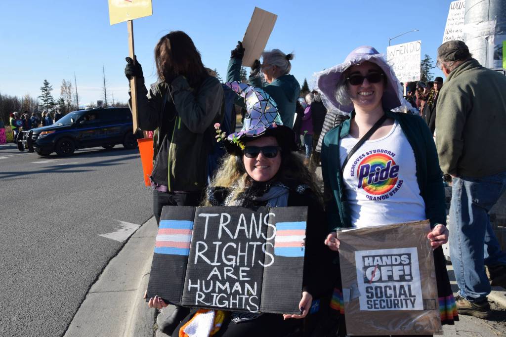 Protesters stand at the corner of Lake Street and the Sterling Highway during the No Kings demonstration on Saturday, Oct. 18, 2025, in Homer, Alaska. (Delcenia Cosman/Homer News)