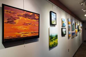 Artwork from a summer painting workshop is on display on the gallery wall in Kachemak Bay Campus's Pioneer Hall on Saturday, Oct. 18, 2025, in Homer, Alaska. (Delcenia Cosman/Homer News)