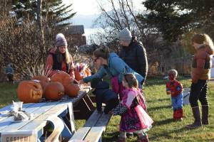 Community members attending Homer Chamber of Commerces third annual Fall Fest vote for their favorite pumpkin created during the events Pumpkin Carving Contest on Saturday, Oct. 26, 2024, at the Homer Chamber of Commerce and Visitor Center in Homer, Alaska. (Delcenia Cosman/Homer News)