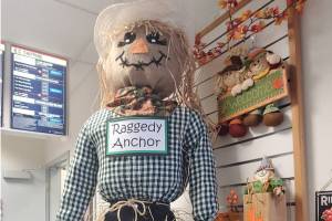 A friendly scarecrow stands on the counter at the Anchor Point Post Office in October 2025 in Anchor Point, Alaska. (Delcenia Cosman/Homer News)