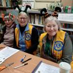 Lady Lions Marcia Lowe, Julie Small and Linda Petkash with the Homer Lions Club conduct sign-ups for Thanksgiving food boxes at the Homer United Methodist Church in Homer, Alaska. More than 230 families requested food boxes this year, an increase from 166 boxes in 2024. Photo provided by Deb Schmidt