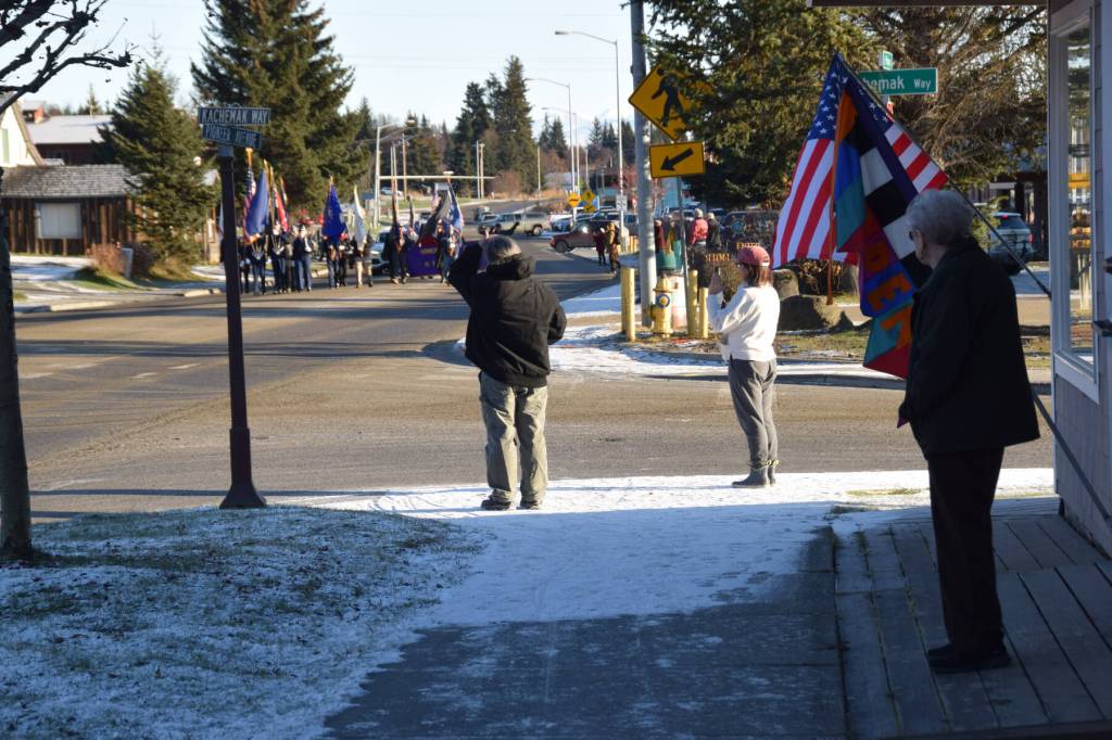 Community members watch parade participants travel down Pioneer Avenue on Veterans Day, Tuesday, Nov. 11, 2025, in Homer, Alaska. (Delcenia Cosman/Homer News)