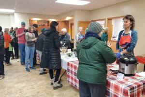 Community members line up for hot soup and bread during the Homer Community Food Pantry's annual Empty Bowl fundraiser on Friday, Nov. 7, 2025, at the Homer United Methodist Church in Homer, Alaska. (Delcenia Cosman/Homer News)