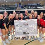 The Kenai Central High School varsity volleyball team holds up the 3A state tournament bracket following the results of the semifinal game on Friday, Nov. 14,<ins> 2025,</ins> at the Alaska Airlines Center in Anchorage<ins>, Alaska</ins>. Photo courtesy of the Kenai Volleyball Booster Club