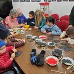 Homer area youth complete holiday crafts inside the Homer Chamber of Commerce during the annual holiday tree lighting ceremony on Thursday, Dec. 4, 2025, in Homer, Alaska. (Delcenia Cosman/Homer News)