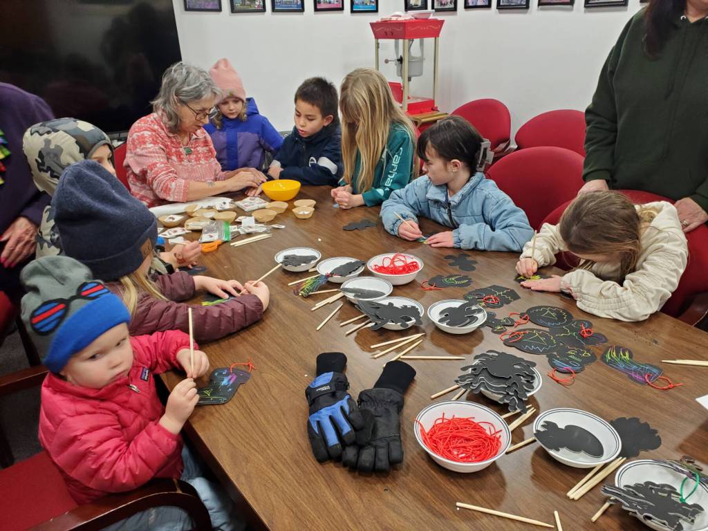 Homer area youth complete holiday crafts inside the Homer Chamber of Commerce during the annual holiday tree lighting ceremony on Thursday, Dec. 4, 2025, in Homer, Alaska. (Delcenia Cosman/Homer News)