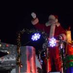 Santa arrives to the annual holiday tree lighting ceremony at the Homer Chamber of Commerce atop a Homer Volunteer Fire Department fire truck on Thursday, Dec. 4, 2025, in Homer, Alaska. (Delcenia Cosman/Homer News)