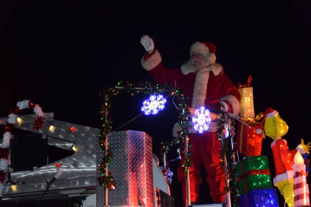 Santa arrives to the annual holiday tree lighting ceremony at the Homer Chamber of Commerce atop a Homer Volunteer Fire Department fire truck on Thursday, Dec. 4, 2025, in Homer, Alaska. (Delcenia Cosman/Homer News)