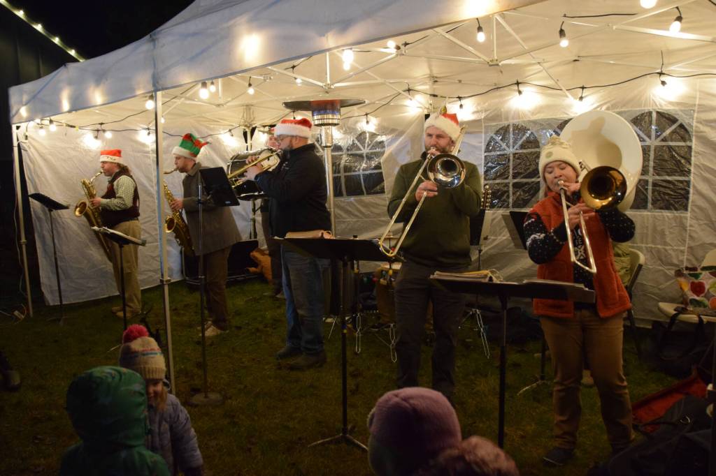 The KP Brass Band plays holiday favorites for the crowd gathered at the Homer Chamber of Commerce on Thursday, Dec. 4, 2025, in Homer, Alaska, for the annual holiday tree lighting ceremony. (Delcenia Cosman/Homer News)