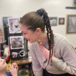 Artist Mira Featherstone is photographed at her Dec. 5, 2025, exhibit opening at Hooligan Tattoo in Anchor Point, Alaska. Photo by Jesse Featherstone