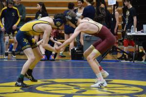A Homer athlete wrestles against a Grace Christian athlete during the regional Kachemak Conference Wrestling Championships on Saturday, Dec. 13, 2025, at Homer High School in Homer, Alaska. (Delcenia Cosman/Homer News)