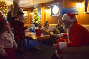 Kids visit with Santa aboard the USCGC Aspen during the inaugural "Jolly Aspen" holiday event and food drive on Thursday, Dec. 17, 2025, in Homer, Alaska. (Delcenia Cosman/Homer News)