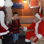 Kids visit with Santa aboard the USCGC Aspen during the inaugural Jolly Aspen holiday event and food drive on Thursday, Dec. 17, 2025, in Homer, Alaska. (Delcenia Cosman/Homer News)