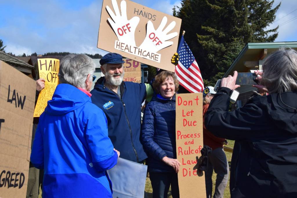 Chloe Pleznac/Homer News 
Former Alaska State House Representative Paul Seaton holds a sign that reads Hands Off Healthcare on Saturday, April 19 at WKFL Park during the Sustained Resistence, Makes a Difference Rally.