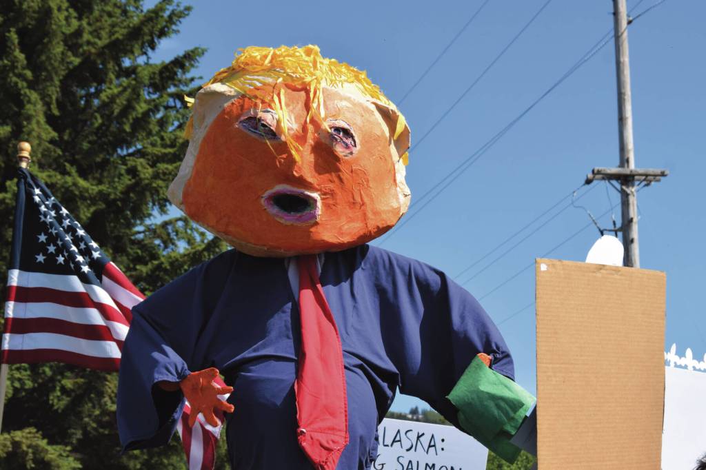 A Trump puppet by local artist Charles Aguilar floats above the crowd during the No Kings protest at WKFL Park on Saturday, June 14, 2025<ins> in Homer, </ins><ins>Alaska</ins>. (Chloe Pleznac/Homer News)