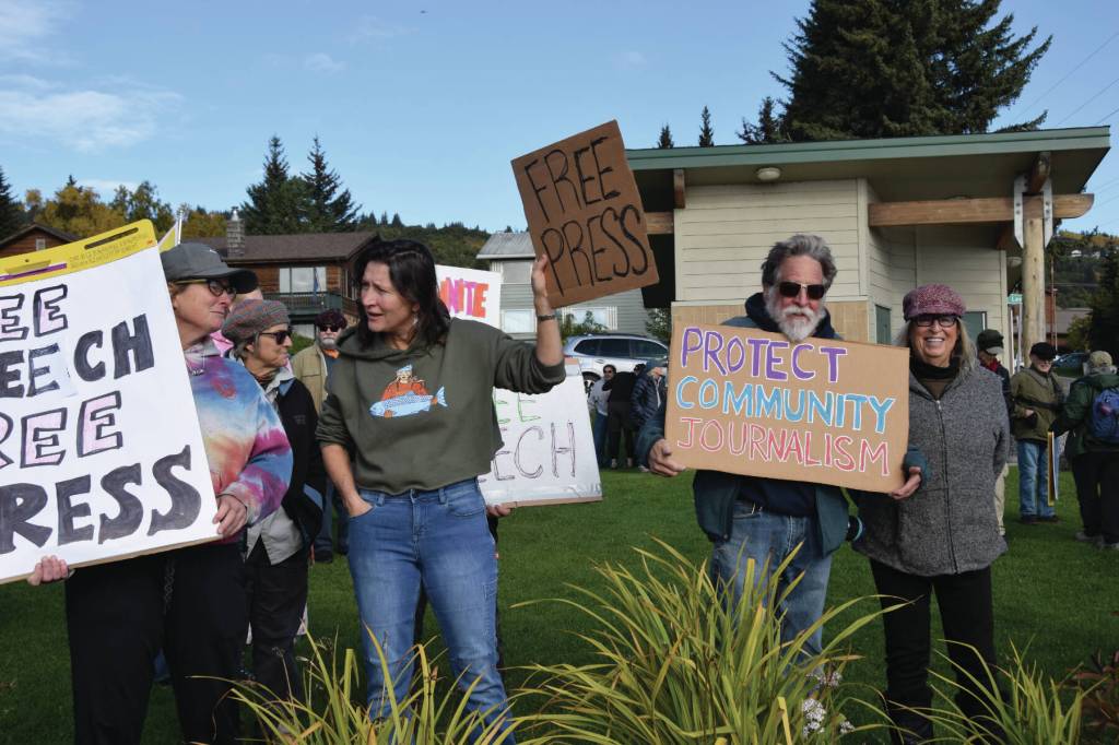 Delcenia Cosman/Homer News 
More than 100 community members, including former Homer News editor Michael Armstrong (right center), hold signs of protest on Sunday, Sept. 28, 2025, at WKFL Park<ins> in Homer, Alaska</ins>. The impromptu rally was held in support of community journalism and constitutional rights to free speech.