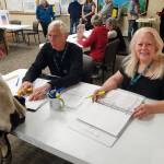 Election workers Susie Myhill (right) and Charlie Franz help voters before they cast their ballots on Election Day, Tuesday, Oct. 7, 2025, in the Homer City Hall Cowles Council Chambers<ins> in Homer, </ins><ins>Alaska</ins>. (Delcenia Cosman/Homer News)