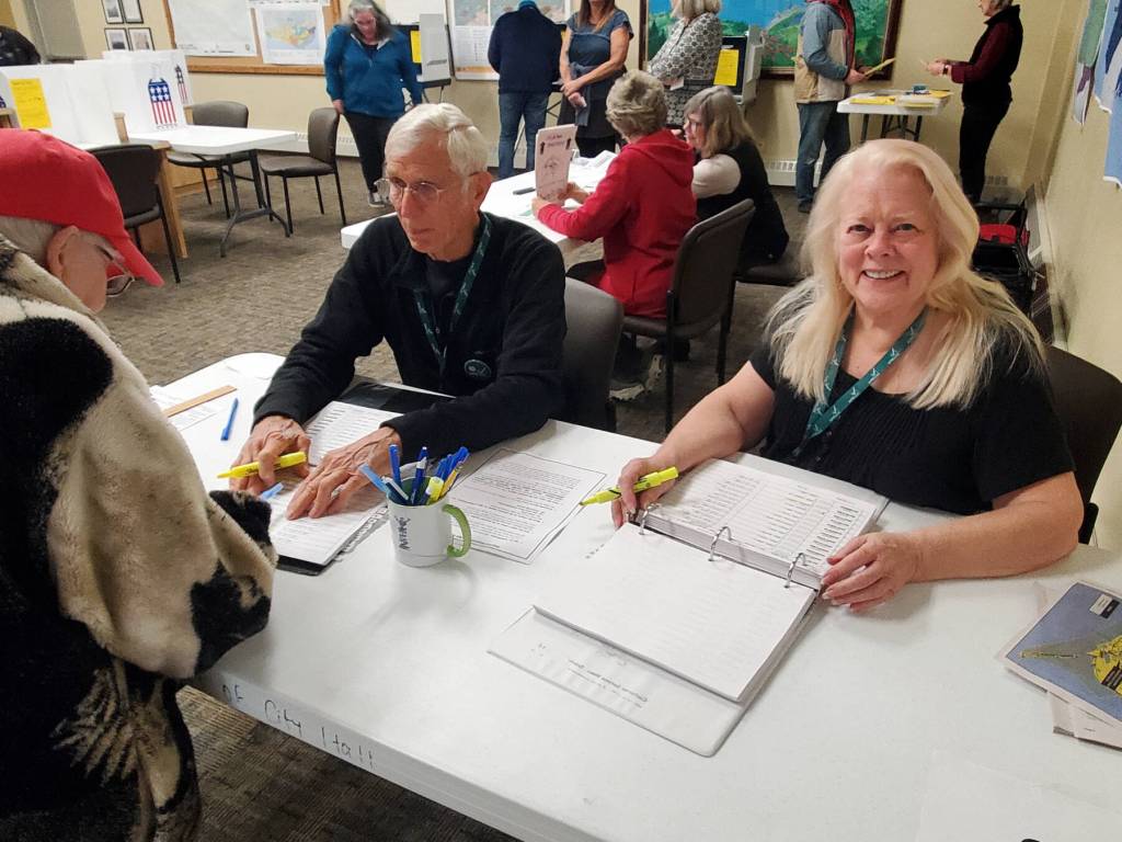 Election workers Susie Myhill (right) and Charlie Franz help voters before they cast their ballots on Election Day, Tuesday, Oct. 7, 2025, in the Homer City Hall Cowles Council Chambers<ins> in Homer, </ins><ins>Alaska</ins>. (Delcenia Cosman/Homer News)