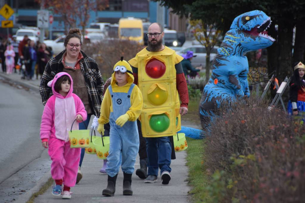 Delcenia Cosman/Homer News 
Families in costumes walk down the sidewalk on their way to different businesses participating in Pioneer Avenue Trick or Treat on Friday, Oct. 31, 2025.<ins>, in Homer, Alaska</ins>