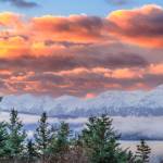Snow-Capped Mountains at Sunrise is a photograph by Steven J. Natanson, on display at Grace Ridge Brewing in Homer, Alaska. Photo provided by Steven Natanson