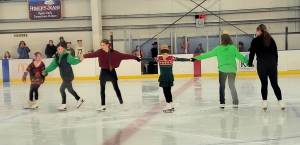 Youth skaters participate in a figure-skating performance during the community Christmas Eve skate on Wednesday, Dec. 24, 2025, at the Kevin Bell Arena in Homer, Alaska. (Delcenia Cosman/Homer News)