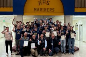 Members of the Homer High School boys and girls cross country teams pose for a photo with coaches and Kenai Peninsula Borough Mayor Peter Micciche following the borough's presentation of a commendation and certificates of achievement to the athletes on Wednesday, Jan. 14, 2026, in Homer, Alaska. Photo courtesy Justin Zank