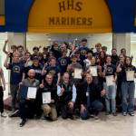 Members of the Homer High School boys and girls cross country teams pose for a photo with coaches and Kenai Peninsula Borough Mayor Peter Micciche following the borough assemblys presentation of a commendation and certificates of achievement to the athletes on Wednesday, Jan. 14, 2026, in Homer, Alaska. Photo courtesy Justin Zank