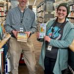 Homer Public Library Technician and Lit Lineup coordinator Matthew Smith (left) and Library Technician Regina Johanos are photographed with this years Lit Lineup books and reading list on Friday, Jan. 23, 2026, in Homer, Alaska. Photo by Christina Whiting