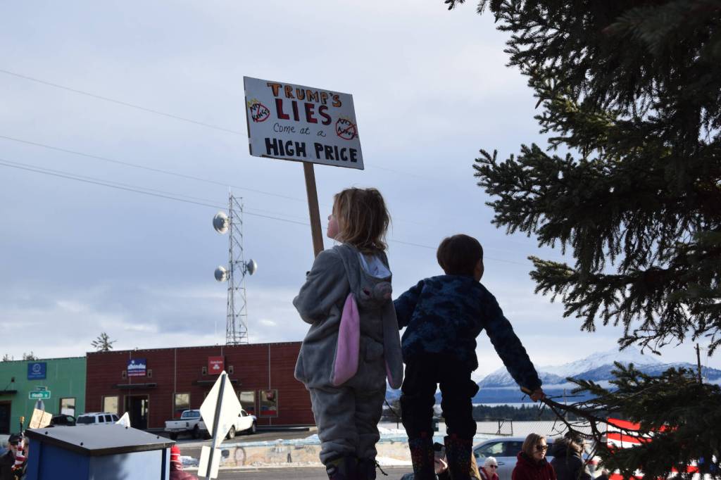 A young protester carries a No Kings sign during the ICE OUT demonstration on Sunday, Feb. 1, 2026, at WKFL Park in Homer, Alaska. (Delcenia Cosman/Homer News)