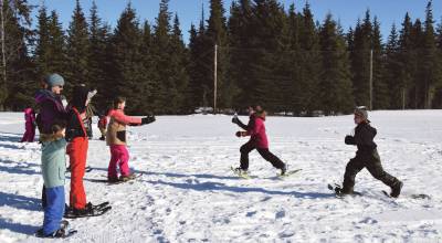 Anchor Point youth run a relay during the Snow Rondi kids snowshoe races on Saturday, March 2, 2024 at Fireweed Meadows golf course in Anchor Point, Alaska. (Delcenia Cosman/Homer News)