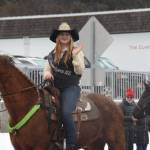 Candace Campbell, the 2025 Ninilchik Rodeo Queen, waves to spectators atop her horse during the Winter Carnival Parade on Saturday, Feb. 14, 2026, in Homer, Alaska. (Delcenia Cosman/Homer News)