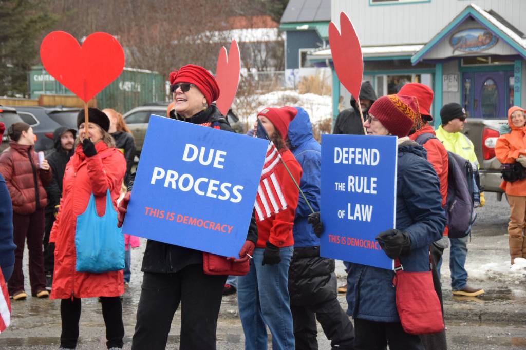 Members of the Homer Women of Action carry signs in line with their theme, Love Democracy, during the Winter Carnival Parade on Saturday, Feb. 14, 2026, in Homer, Alaska. (Delcenia Cosman/Homer News)