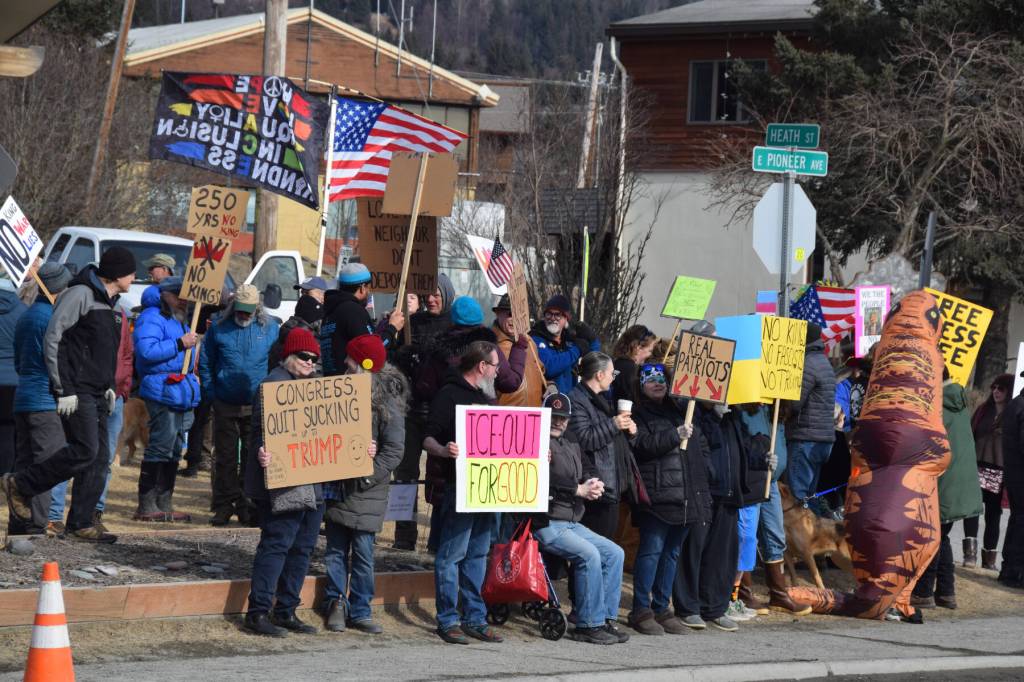 Protesters carry signs as part of the third nationally-organized No Kings protest at WKFL Park on Saturday, March 28, 2026, in Homer, Alaska. (Delcenia Cosman/Homer News)