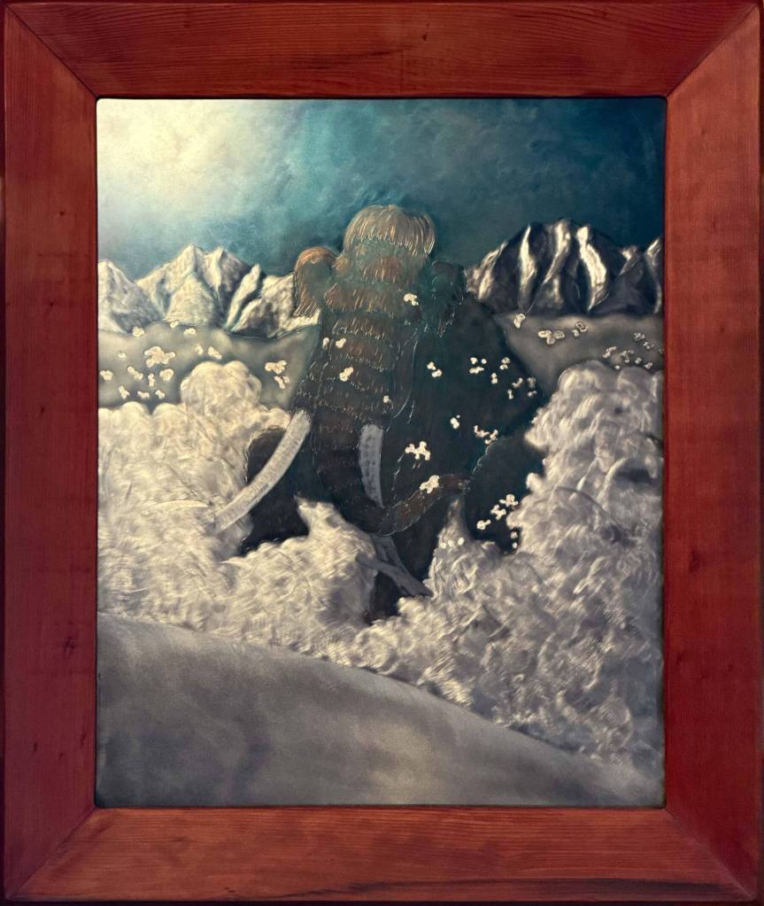 Morning Rampage is an engraving by Jeff Dean of a mammoth charging through the snow, framed with reclaimed redwood and on display at The Dean Gallery in Homer, Alaska. Photo provided by Jeff Dean