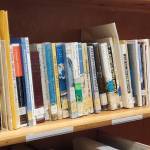 Titles by literary pioneer Elsa Pedersen are available at the Pratt Museum Reference Library, seen here during an open house held on Friday, March 27, 2026, in Homer, Alaska. (Delcenia Cosman/Homer News)