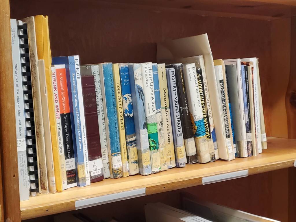 Titles by literary pioneer Elsa Pedersen are available at the Pratt Museum Reference Library, seen here during an open house held on Friday, March 27, 2026, in Homer, Alaska. (Delcenia Cosman/Homer News)