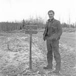 The Y junction in Soldotna was a little less obvious in its early days. Here, Alaska Road Commission engineer Louie Hendricks poses next to a directional sign indicating which way to turn for either Kenai or Moose Pass. (Photo courtesy Al Hershberger)