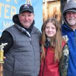Aaron Challans from Soldotna poses with his daughter and 2025 Top Youth Angler winner Madelyn Challans (center) and Homer Chamber of Commerce executive director Brad Anderson (right) after winning 10th place during the 32nd annual Homer Winter King Tournament on Saturday, April 4, 2026, in Homer, Alaska. (Delcenia Cosman/Homer News)