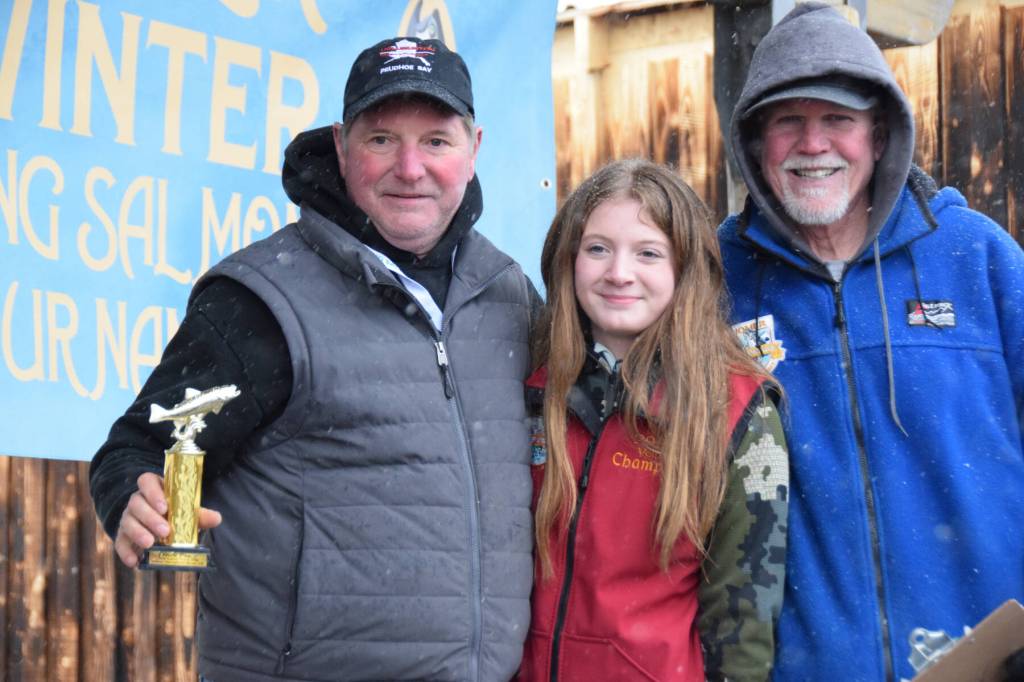 Aaron Challans from Soldotna poses with his daughter and 2025 Top Youth Angler winner Madelyn Challans (center) and Homer Chamber of Commerce executive director Brad Anderson (right) after winning 10th place during the 32nd annual Homer Winter King Tournament on Saturday, April 4, 2026, in Homer, Alaska. (Delcenia Cosman/Homer News)