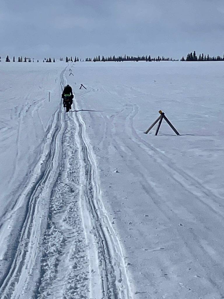 Forest Wagner of Fairbanks rides his fat bike toward the village of Unalakleet on April 12, 2026. (Photo by Ned Rozell)